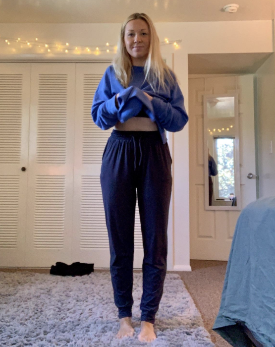 A reviewer wearing the joggers in navy blue.