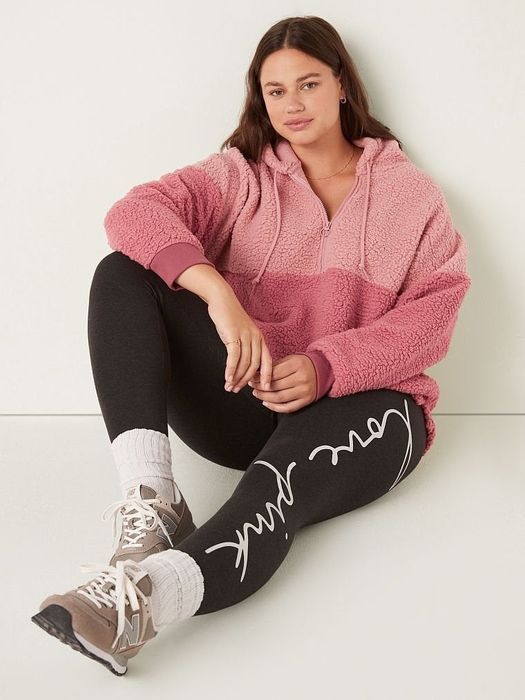 Another model in a pink sherpa pullover.