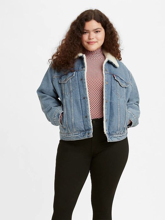 A model showcasing a denim jacket with a cozy sherpa lining.