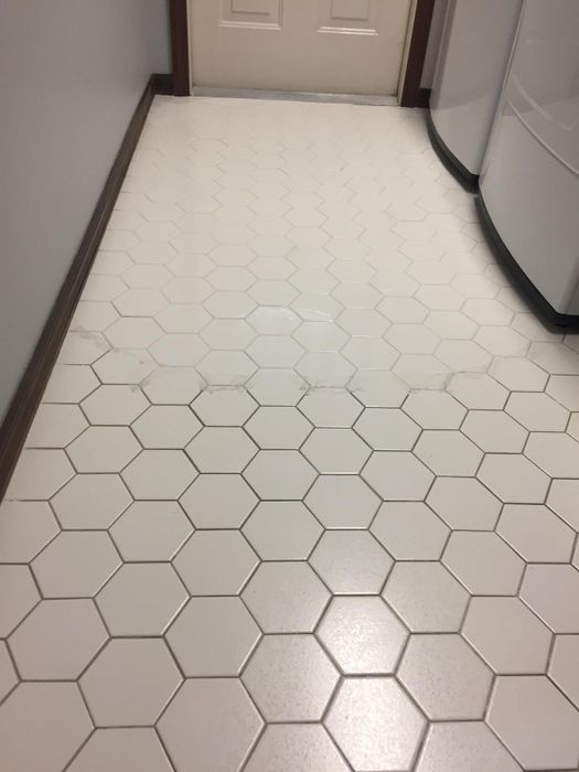 A reviewer showing off the grout they've cleaned using the detailing brushes.