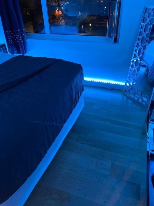 Another reviewer placing the blue LED string along the bottom of their wall for a cozy glow.
