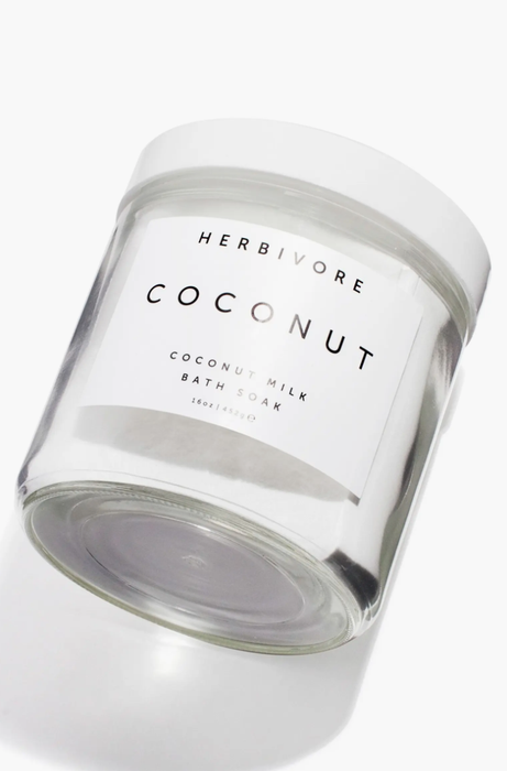 Herbivore Coconut Milk Bath Soak jar, labeled with product details, ideal for enhancing bath time luxury and skincare routines