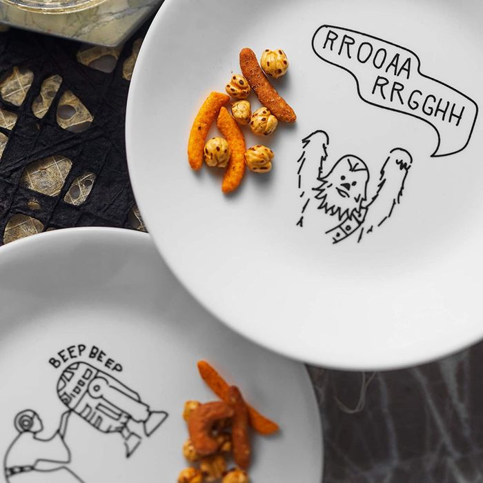 The white plates decorated with bold black illustrations.