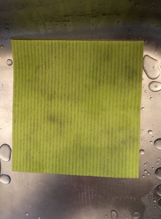 The same dishcloth, now completely clean after being rinsed in the sink.