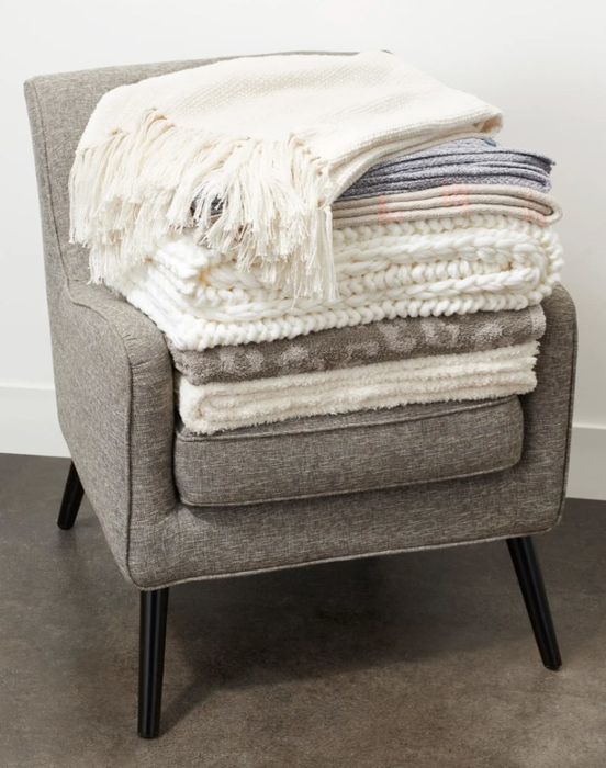 A stack of multiple cozy blankets