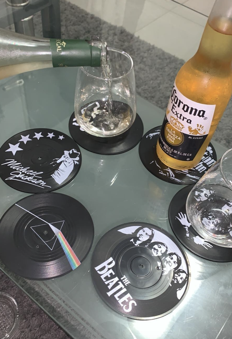 A set of black vinyl record coasters.