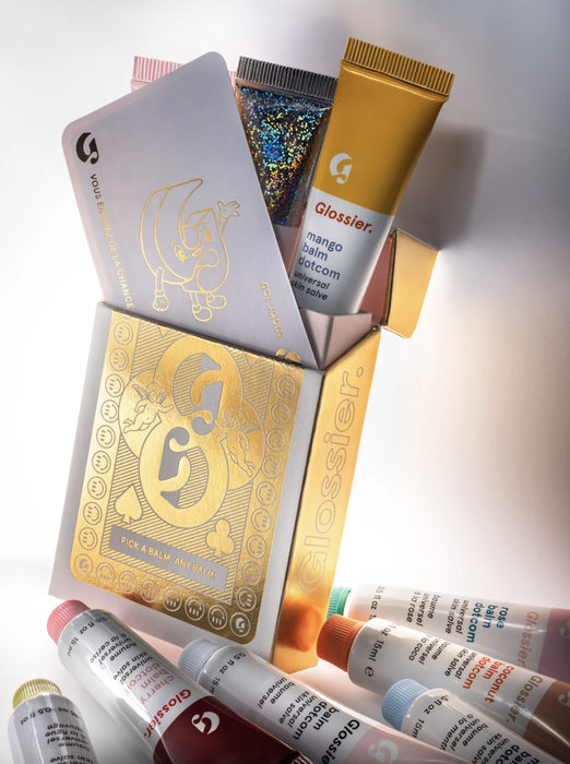 The gold packaging, which holds three balms inside.