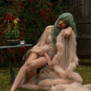 Reviewer showcasing the robe styled over lingerie, creating a bold and stylish look.