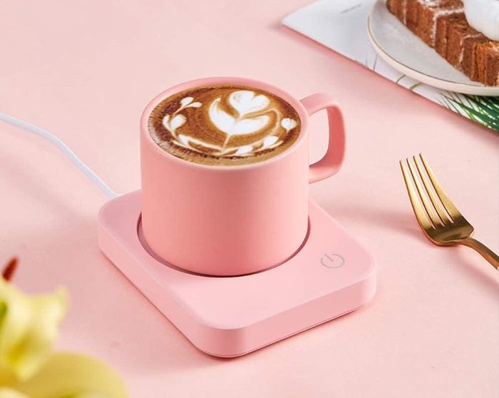 A pink desktop mug heater, perfect for keeping your coffee warm.