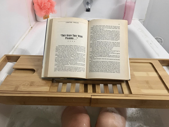A reviewer photo of the wooden bamboo bathtub tray.
