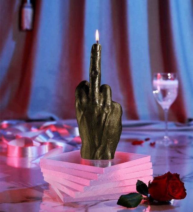 Candle shaped like a hand with the flame emerging from the middle finger, ideal for a humorous yet thoughtful gift