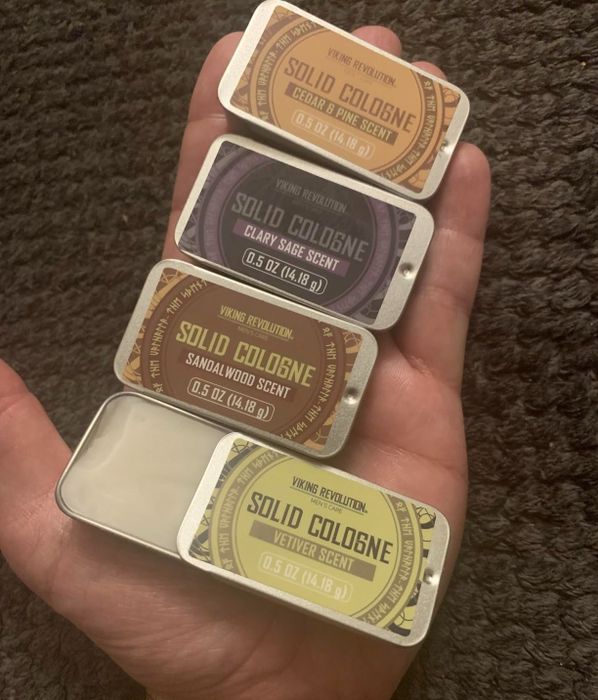 A photo shared by a reviewer showing a hand holding all four cologne scents