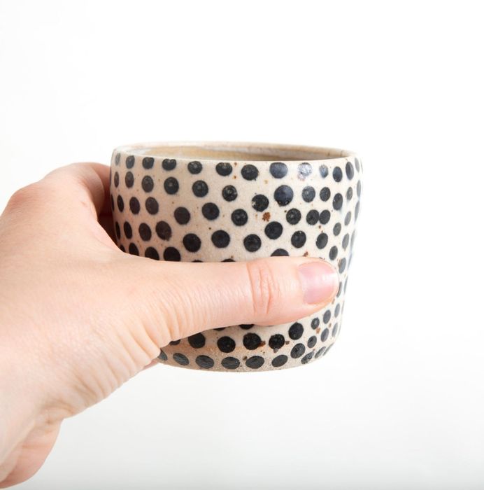 The ceramic tumbler featuring black polka dots