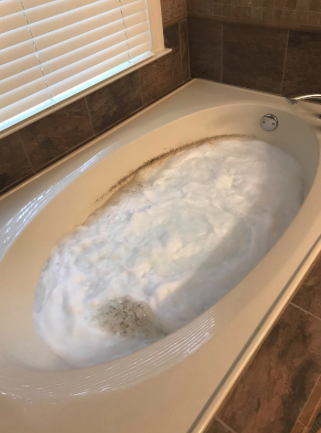 Gunk being cleared out of a reviewer's tub
