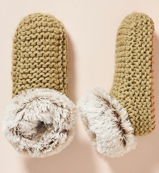 A pair of yellow faux fur slipper booties.