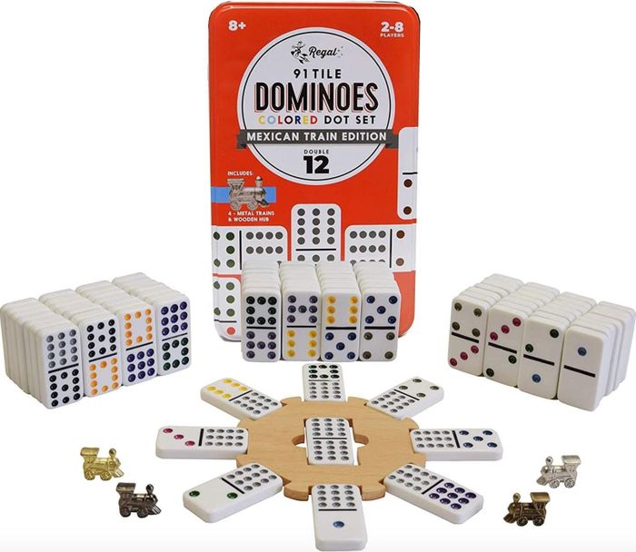 A set of dominos with tiles spread out and stacked neatly