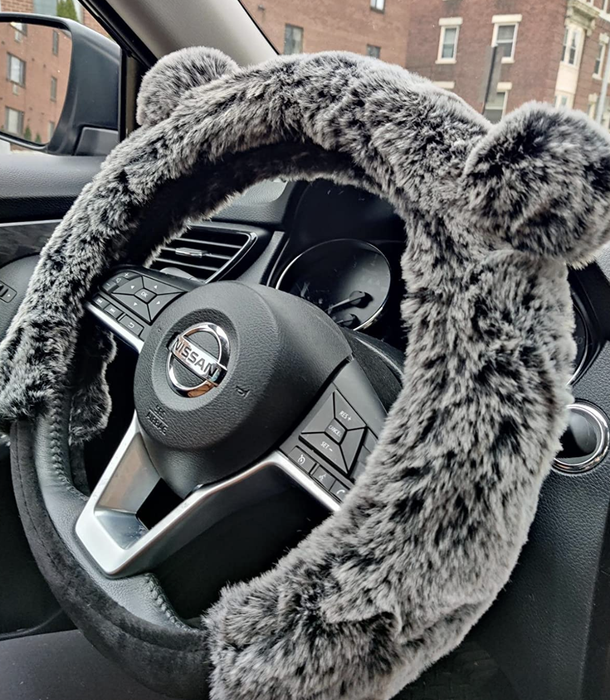 A photo of the gray bear cover on the steering wheel.