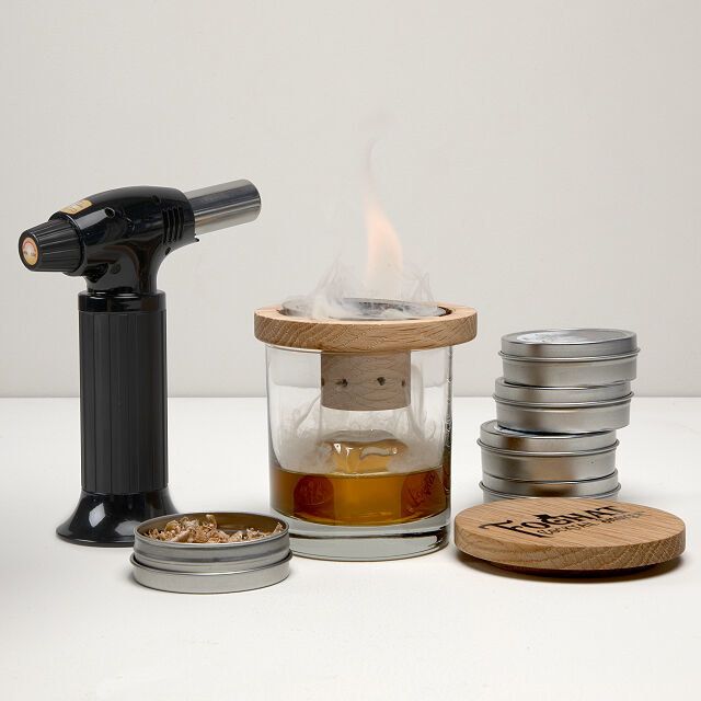 A cocktail smoker kit in action, creating a smoky effect for drinks