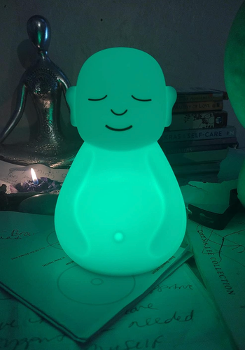 The figurine radiates a vibrant green glow.