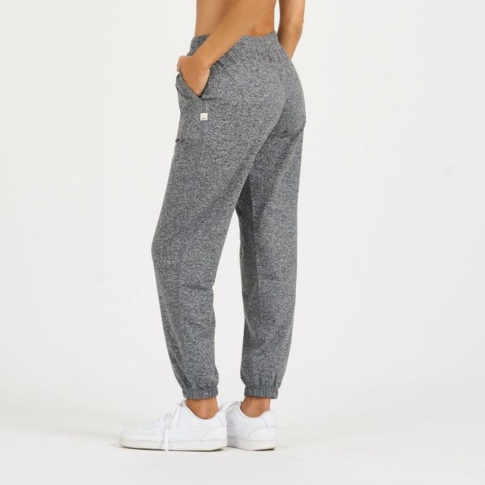 Model showcasing gray boyfriend joggers in a casual setting.