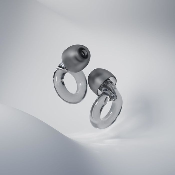 Two sleek, transparent loop-shaped earbuds resting on a smooth, white backdrop