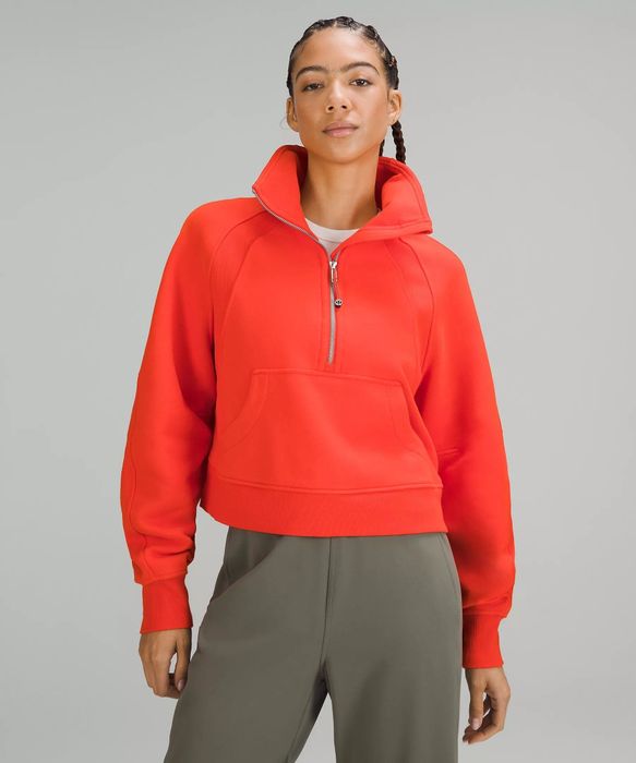 A photo of a model wearing an orange sweatshirt
