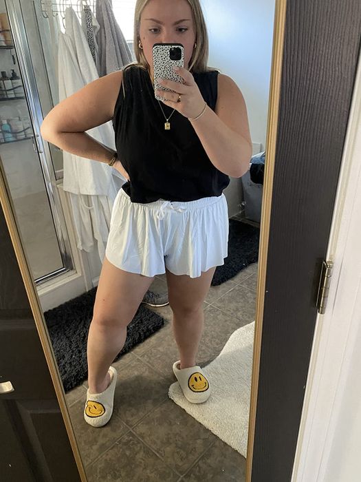 reviewer showcasing the white shorts