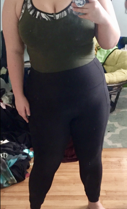a reviewer modeling the high-waisted black leggings