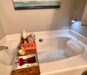 The pillow fully submerged in a bath, providing perfect support while soaking.