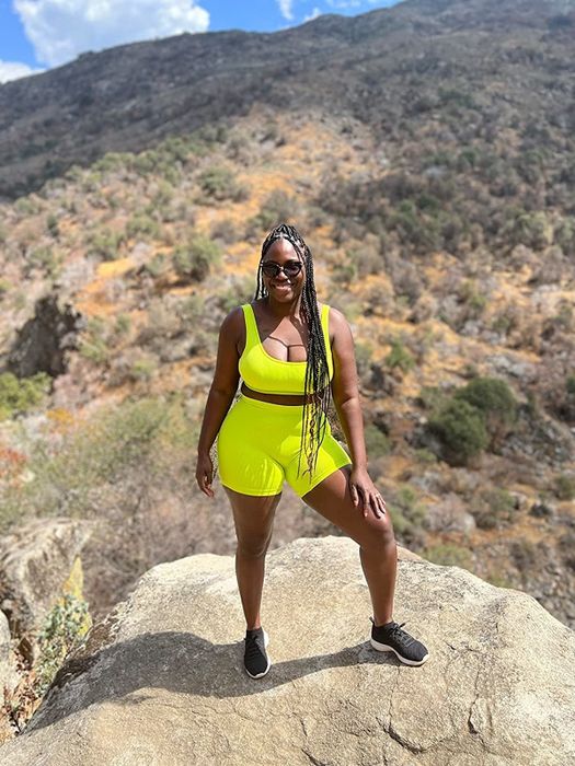 A reviewer showcasing the neon yellow workout set