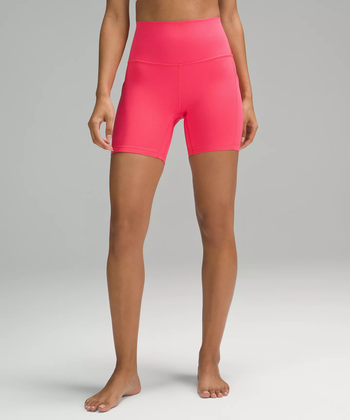 a model wearing pink Lululemon bike shorts
