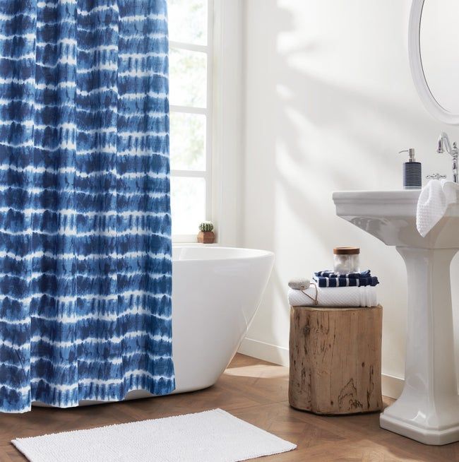 the blue and white tie-dye shower curtain displayed in a bathroom