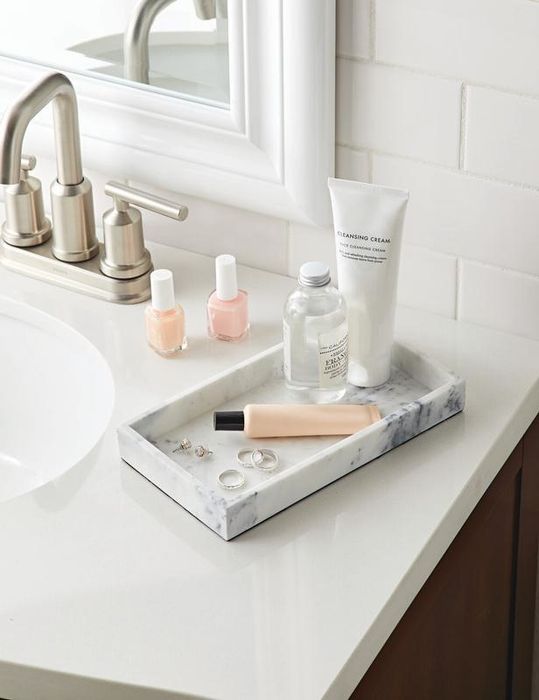 a decorative vanity tray designed with a faux marble finish