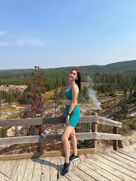 a reviewer sporting a sports bra and green cycling shorts