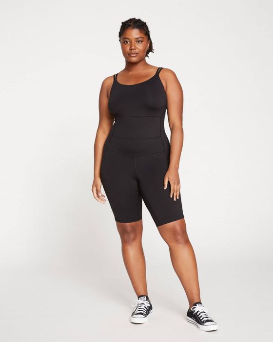 a model showcasing a sleek black bodyshort suit