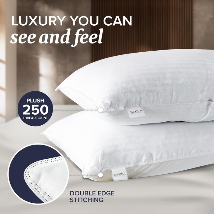 Two luxury plush pillows, featuring a 250-thread count and double-stitched edges, designed to offer a tactile experience of superior comfort.