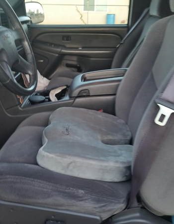 A pillow placed on the seat of a car.