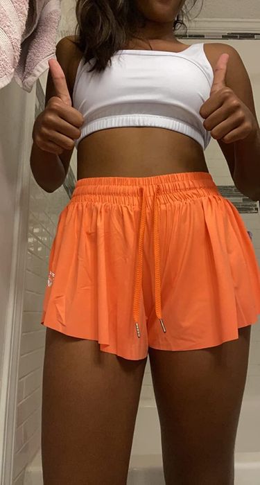 reviewer modeling the orange shorts