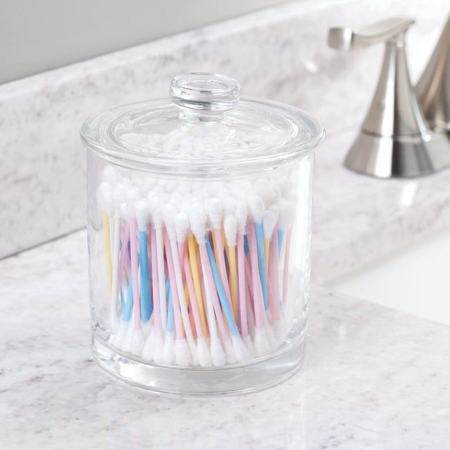 the glass vanity jar filled with cotton swabs