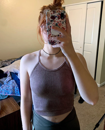 A reviewer showcasing the dark purple version of the same top