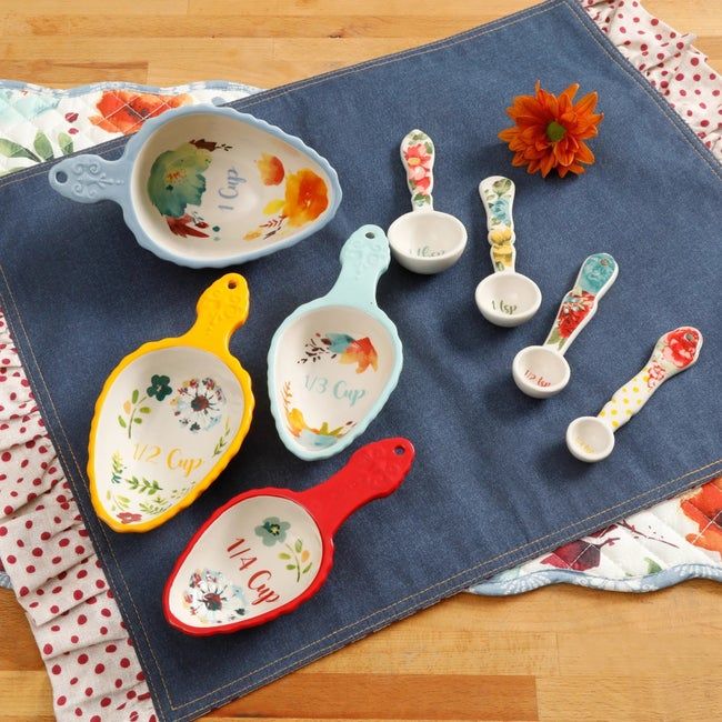 A colorful collection of measuring spoons and cups, perfect for both practical use and brightening up any kitchen space.