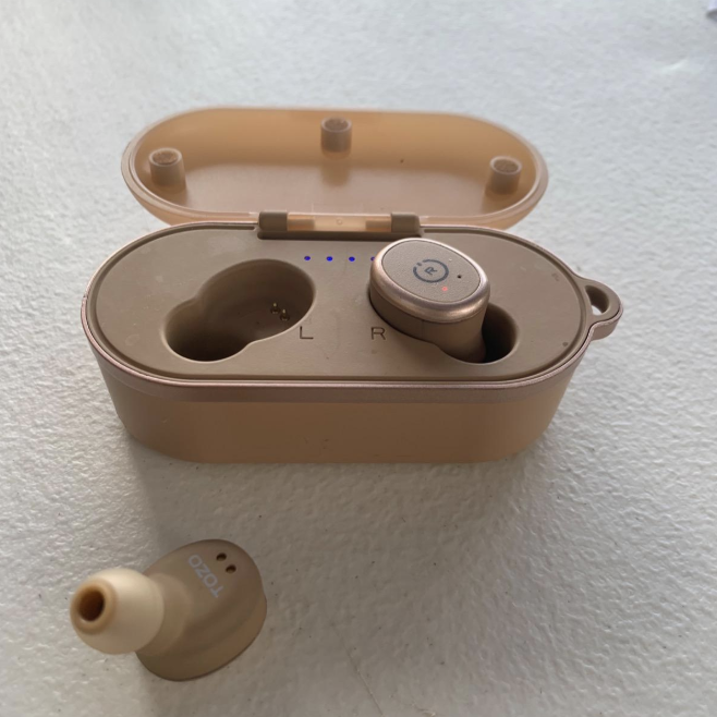 A pair of rose gold wireless earbuds