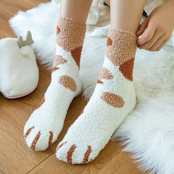 The upper section of socks featuring fun spots and tiny paw prints.