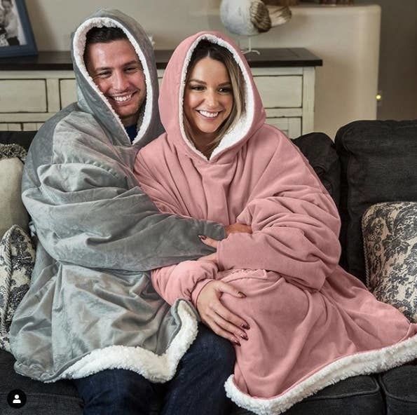 Two people snuggled up together in the blankets