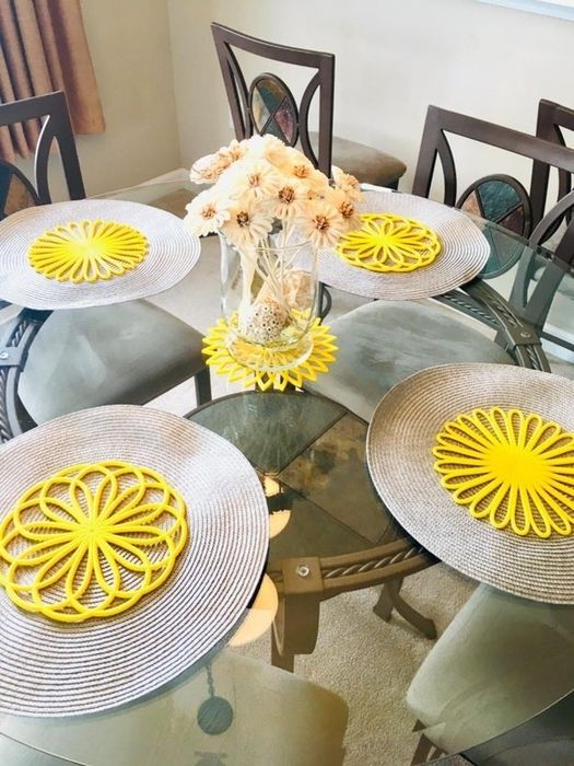 The vibrant yellow trivet mats elegantly set up on a table.