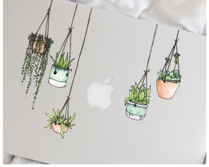 Hanging planter stickers placed on the front of a MacBook.