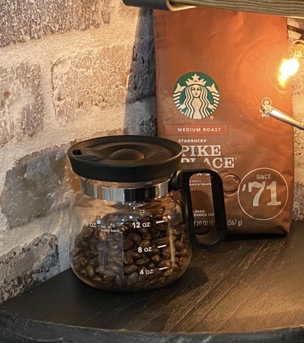 A reviewer photo of the mug filled with coffee beans.