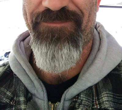 A person with a well-groomed beard that uses the balm for optimal care and style.
