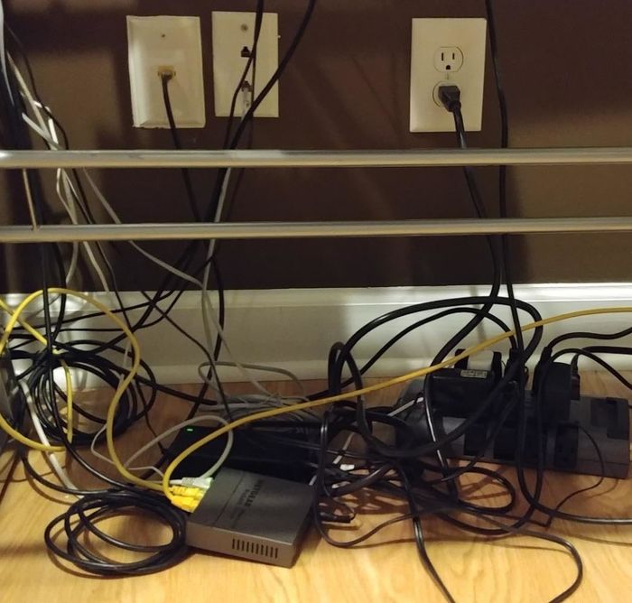 A reviewer showing a chaotic mess of tangled cords scattered across the floor.