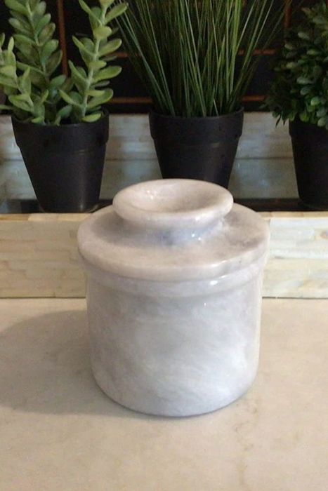 The butter keeper, complete with its lid securely in place, keeping butter at the perfect spreadable consistency.